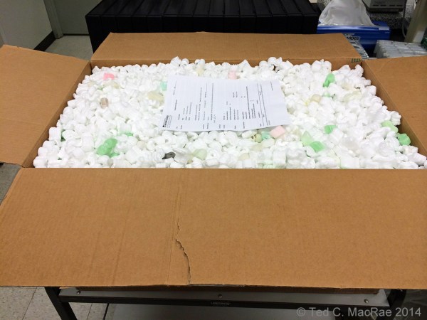 Opened shipping box w/ paperwork