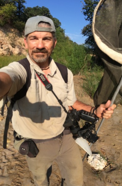 Ted MacRae w/ field collecting equipment & camera